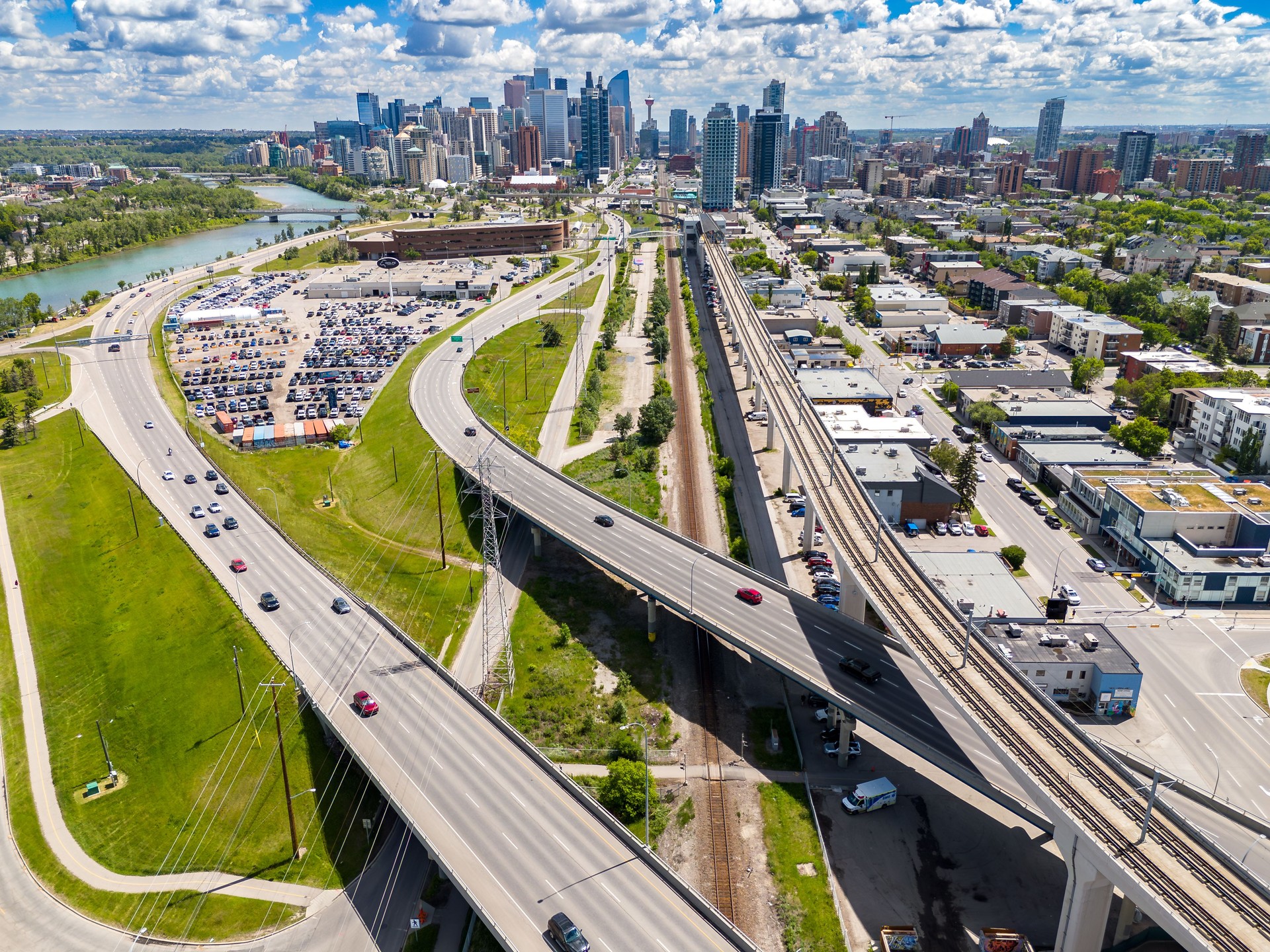 Calgary skyline aerial overlooking commuter traffic and elevated public transit lines